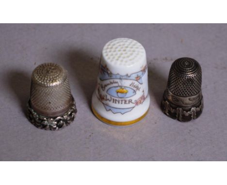 Two silver thimbles together with Royal Doulton porcelain 'Winter' thimble.