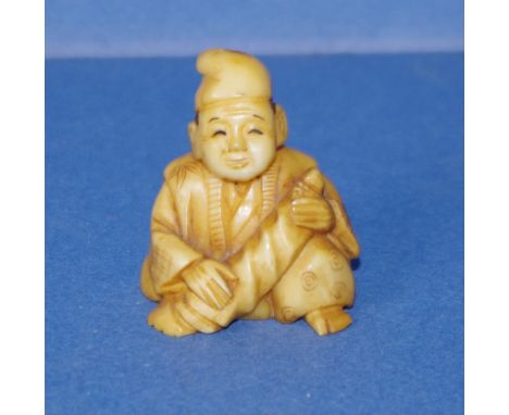 Vintage Japanese ivory netsuke Seated man. May not be exported without CITES documentation. Signed to base. Height 4cms appro