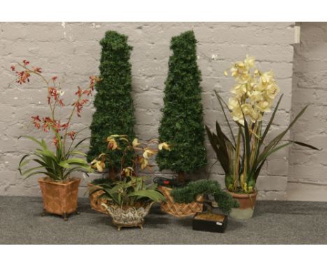 A collection of artificial plants in pots to include a pair of light up trees.