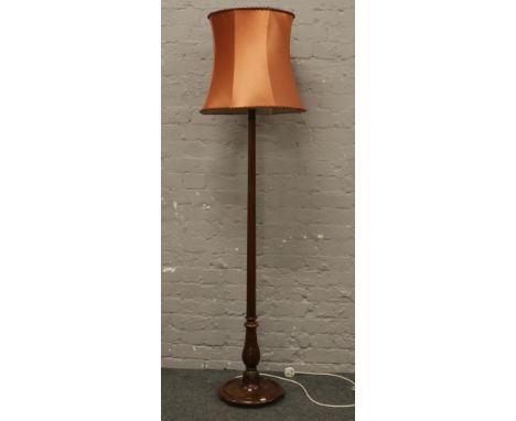 A carved and reeded mahogany standard lamp and shade.