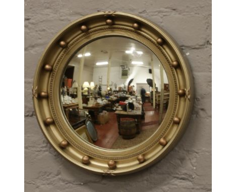 A gilt frame Atsonia convex mirror, diameter 43cm.