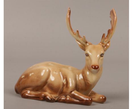 A Beswick ceramic figure of a recumbent deer.