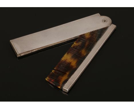 A silver mounted and tortoise shell effect folding moustache comb.Condition report intended as a guide only.One spine lacking