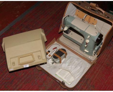 A cased vintage Lada sewing machine along with a cased Smith - Corona typewriter.