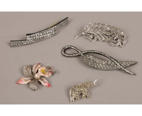 Three vintage marcasite brooches one formed as an orchid ans with enamelled decoration along with two hat flashes.