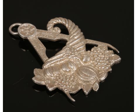 A silver Masonic pendant formed as a compass and cornucopia, assayed Birmingham 1919.