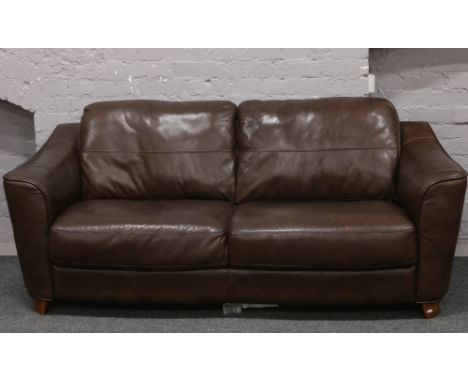 A good quality brown leather three seat sofa.