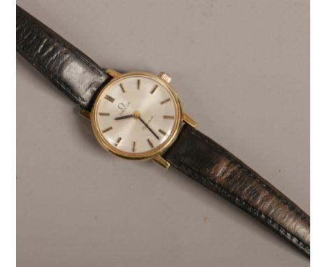 A ladies yellow metal Omega Geneve manual wristwatch on leather strap with satin dial and applied baton markers.Condition rep
