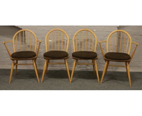Four Ercol Golden Dawn spindle back dining chairs to include two carver arm examples.