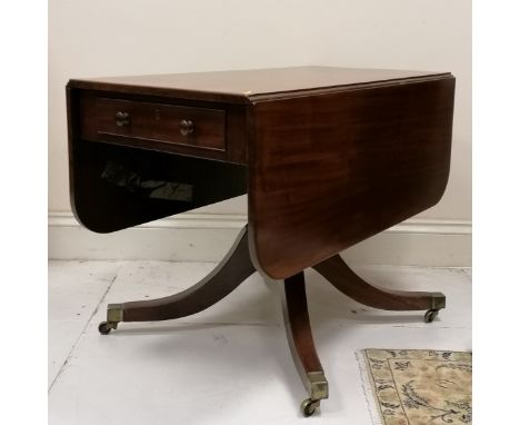 Antique mahogany drop flap tea table, on turned column on 4 splayed legs terminating brass castors, 101 cm length,  128 cm wi