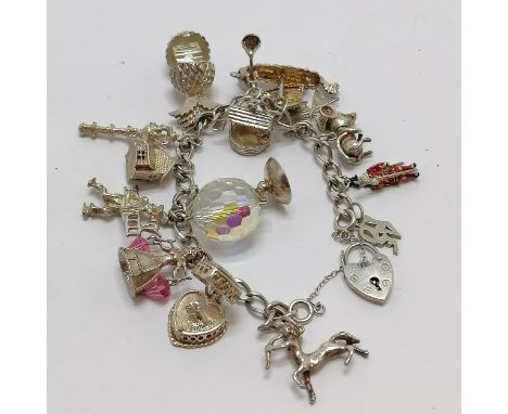 Silver charm bracelet with charms inc pineapple (with aloha inside), enamel beefeater, viking ship, mouse etc - total weight 