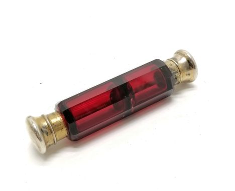 Antique ruby glass double ended scent bottle with unmarked silver gilt lids 12cm long - small dents to 1 lid otherwise in goo