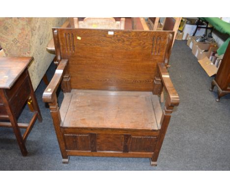 A 1930s oak monk's bench of traditional form
