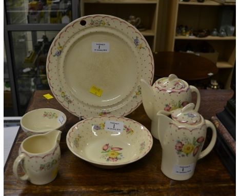 Six pieces of Susie Cooper earthenware, including warming dish, kestrel shaped hot water pot, cream, etc with 'leaping deer',