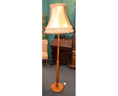 A beech standard lamp, with tasselled shade