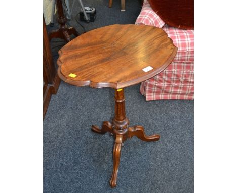 A Victorian figured walnut cartouche topped tripod table with decorative base