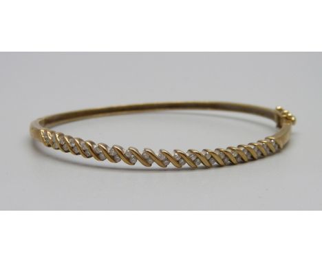 A 9ct gold bangle set with 38 diamonds, 7g, 0.5ct diamond weight 
