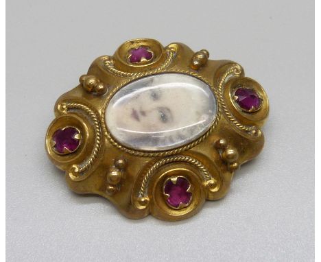 A 19th Century gold plated portrait brooch set with red stones 