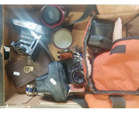 A collection of photographic equipment to include an Olympus OM10 film camera, cased Carl Zeiss Jena lens, vintage cased bell