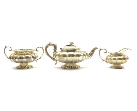 William IV silver teapot and milk jug of lobed circular design, the teapot with floral lift and leaf capped handle London 183