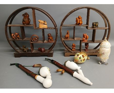 Modern wood netsuke (some signed) with display shelves, 2 ceramic pipes depicting a fox and a stag, and 2 egg shaped decorati