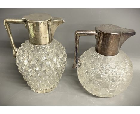 2 silver mounted cut glass Christopher Dresser influence claret jugs with hobnail &amp; pineapple decorated bodies. John Grin