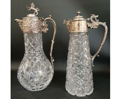 2 Victorian cut glass claret jugs with silver plated mounts - one&nbsp;with Bacchus mask spout, the hinged cover with rampant