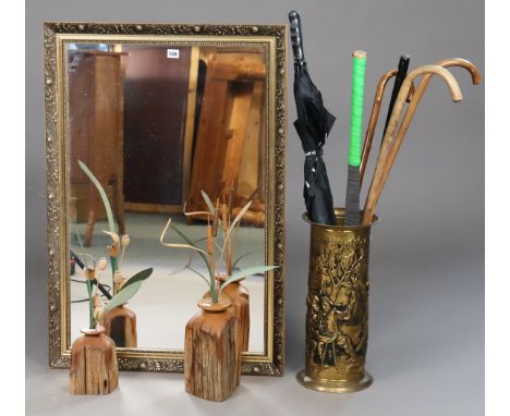 A gilt frame rectangular wall mirror, 96cm x 65.5cm; together with a brass embossed stick stand; three walking canes; two tre
