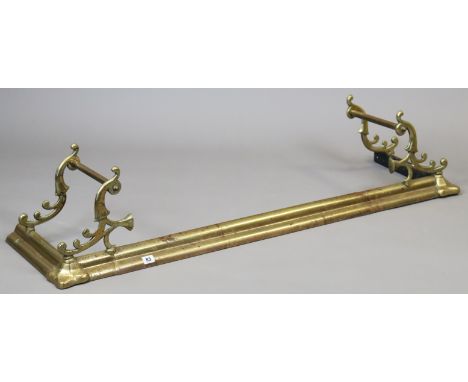 A 19th century-style brass fender with scroll end supports, 145cm high.