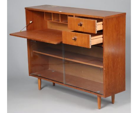 A 1970’s Avalon teak side cabinet with cupboard to the left-hand side &amp; centre enclosed by a fall-front, fitted two long 