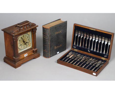 An early 20th century mantel clock with a silvered dial, chiming movement, &amp; in a walnut case, 36cm high; together with a