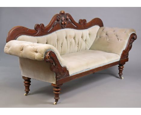 A Victorian mahogany sofa with carved &amp; pierced decoration to the scroll ends, padded seat, back &amp; arms upholstered m