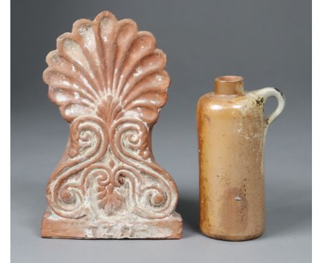 A terracotta roof-ridge tile, 14.75cm wide x 23.5cm high; &amp; a small stoneware ewer, 17cm high.