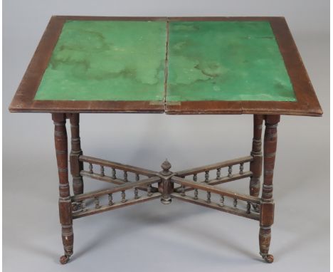 A 19th century mahogany card table inset green baize to the rectangular fold-over top, on four ring-turned tapered legs with 