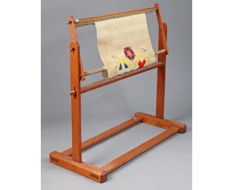 A pine tapestry frame on square end supports with plain stretchers, 110cm wide.
