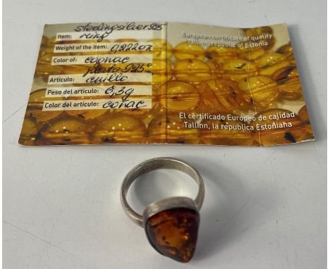 A 925 Silver marked Estonian Baltic Amber ring with certificate card. Size U and weighs 6.3g approx.
