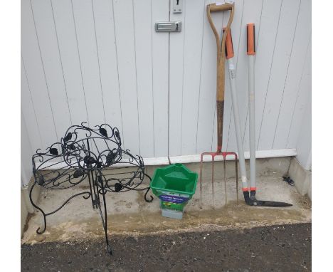 A collection of garden tools to include a pair of edging shears, garden fork, hand operated spreader and an ironwork folding 
