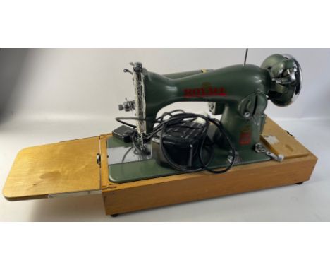A ROYALI deluxe electric sewing machine with foldable small hinged work-platform with its own built-in lightApprox 1 pieces