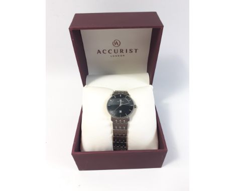 A boxed gent's titanium ACCURIST watch with black face and silver numerals, (Japan MVT GL10) model 8172,  face measures 3cm. 