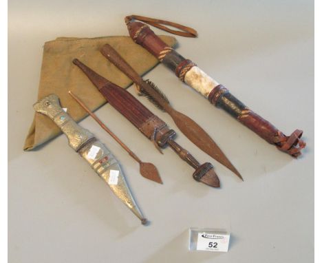 Two small Middle Eastern daggers, one with white metal foliate design covering to the scabbard and grips, set with semi-preci