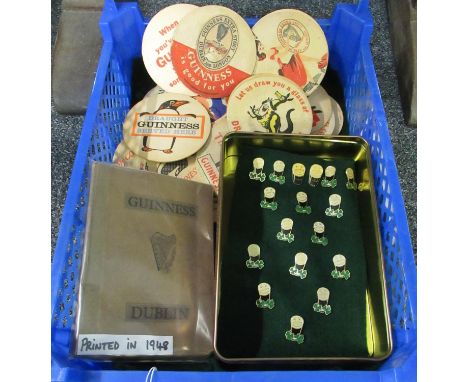 Box of Guinness memorabilia to include book on history of Guinness factory printed in 1948, collection of badges: two Guinnes