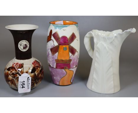 Two vases and a jug to include: polychrome Crown Ducal vase decorated with windmills in stylistic form, a Jersey pottery vase