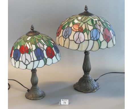Two similar reproduction Tiffany style mushroom lamps with lead glazed shades on bronzed bases. 47cm &amp; 43cm high approx. 