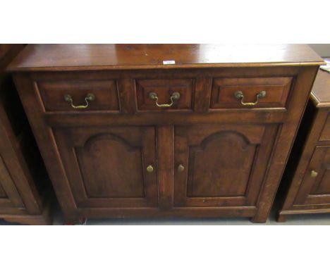 Reproduction 18th century style Welsh oak short dresser base with three frieze drawers over two arch fielded panel cupboards.