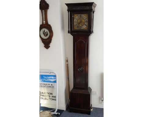 An 18th century 30-hour oak longcase clock;&nbsp;ogee-style cornice above a blind fret carved frieze and 11-inch brass dial w