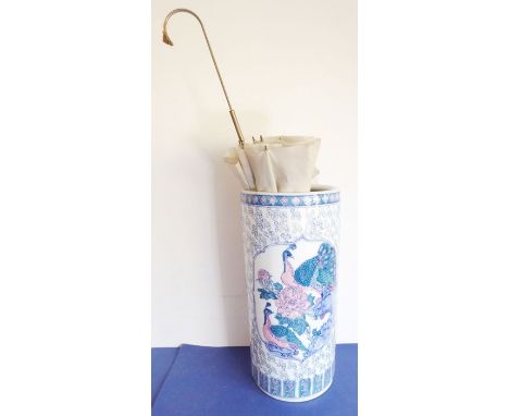 A large Chinese cylindrical porcelain vase decorated with exotic birds and with lotus-style base, together with the parasol w