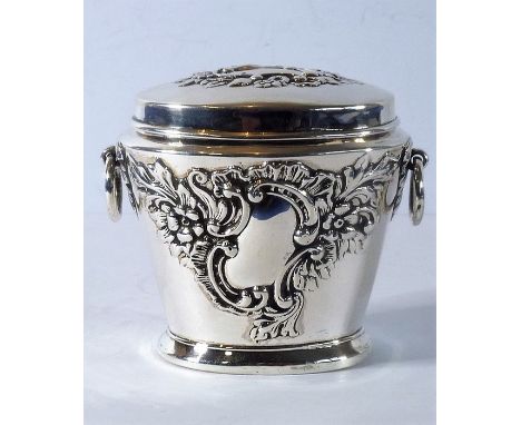 A late Victorian silver miniature tea caddy with embossed decoration and ring handles; James and William Deakin, hallmarked C