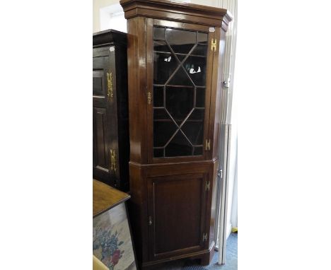A George III-style freestanding mahogany corner cupboard; single glazed door with astragal glazing bars and a panelled door b