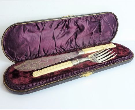 A late 19th century cased set of fish servers;&nbsp;silver-plate blades and carved ivory handles (slice and large fork)