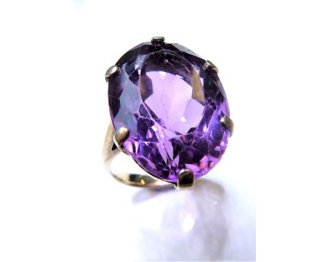 An amethyst single stone ring, the oval mixed-cut amethyst (measuring 2.2cm x 1.5cm), claw-set to the ornately-pierced galler